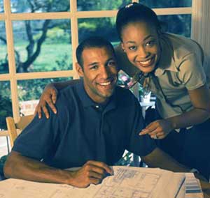 picture of couple looking at house plans